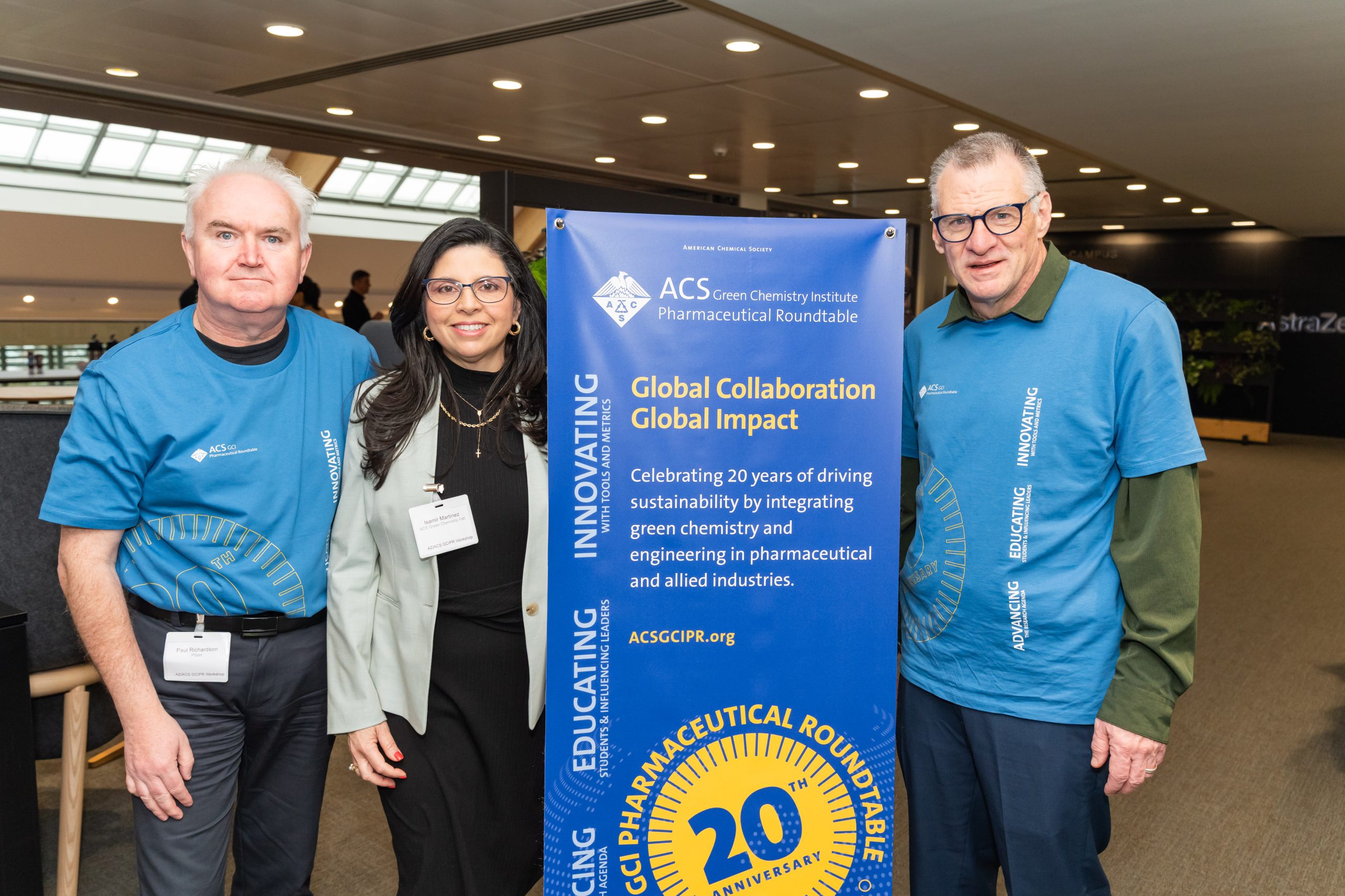 GCIPR co-chairs Paul Richardson and Mike Kopach with Isamir Martinez and the 20th anniversary banner.